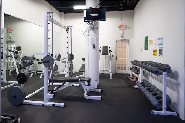 workout area featuring a high ceiling