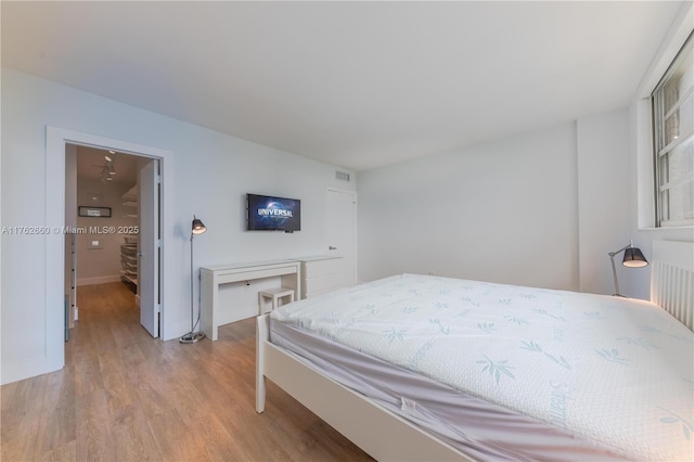 bedroom with light wood-type flooring and visible vents