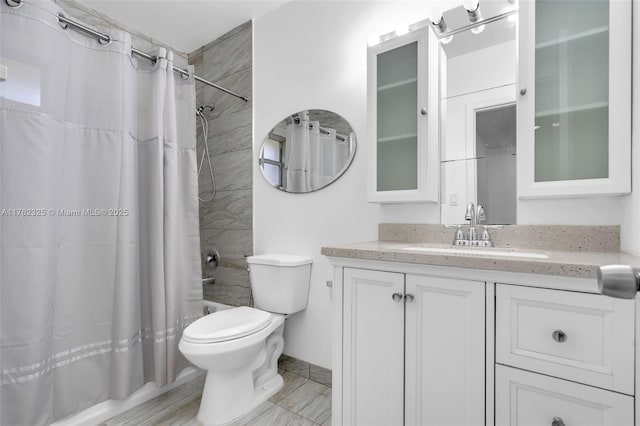 bathroom featuring shower / bathtub combination with curtain, toilet, and vanity