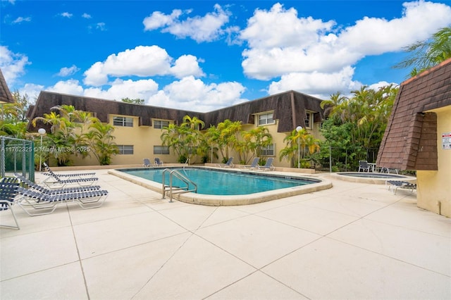 community pool with a patio area