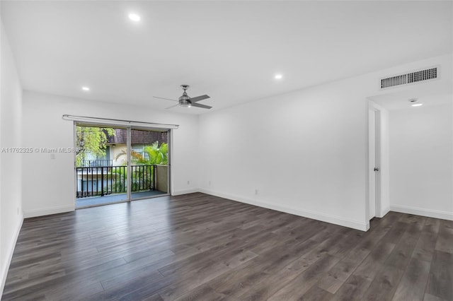 spare room featuring dark wood finished floors, visible vents, and recessed lighting