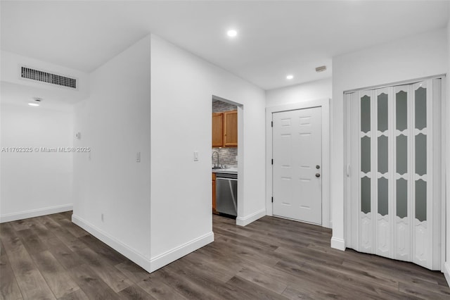 interior space with recessed lighting, visible vents, baseboards, and dark wood-type flooring