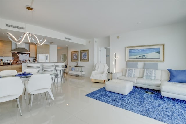 living room featuring light tile patterned floors and visible vents