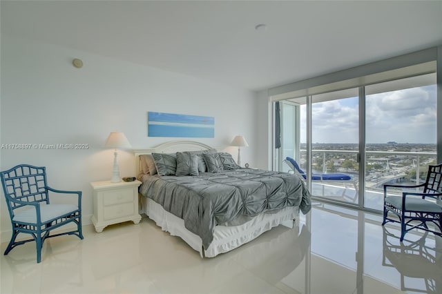 bedroom with floor to ceiling windows and access to outside