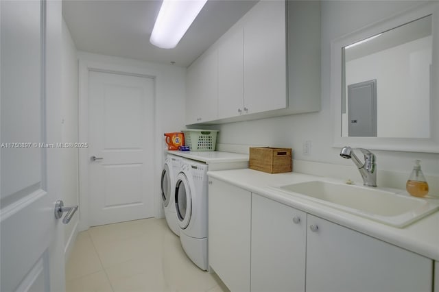 clothes washing area featuring washer and dryer, cabinet space, light tile patterned floors, and a sink