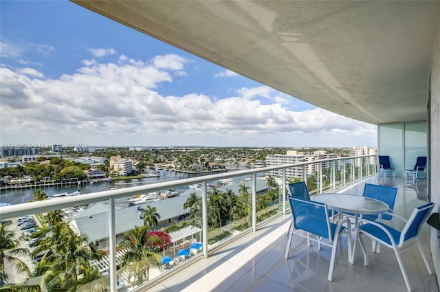 balcony featuring a view of city and a water view