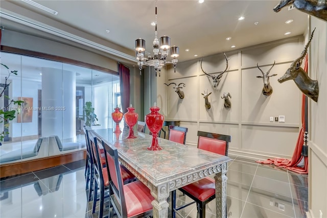 dining room featuring tile patterned floors, a chandelier, recessed lighting, and a decorative wall