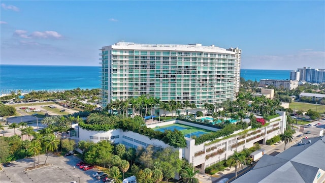 birds eye view of property with a water view and a view of city