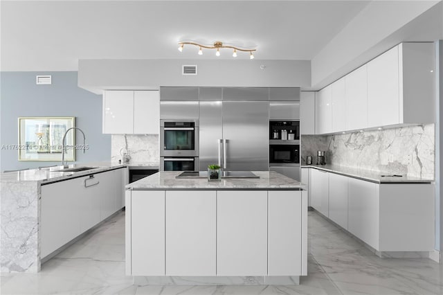 5500 Island Estates Dr Unit 604, Aventura, FL 33160 - kitchen featuring a peninsula, a sink, appliances with stainless steel finishes, modern cabinets, and marble finish floor