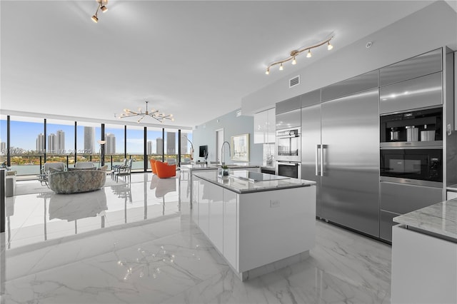 5500 Island Estates Dr Unit 604, Aventura, FL 33160 - kitchen featuring visible vents, marble finish floor, modern cabinets, an inviting chandelier, and light stone countertops