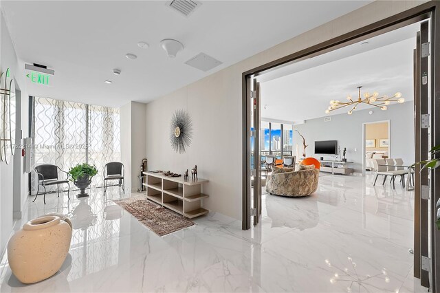 5500 Island Estates Dr Unit 604, Aventura, FL 33160 - living area featuring visible vents, a notable chandelier, marble finish floor, and floor to ceiling windows
