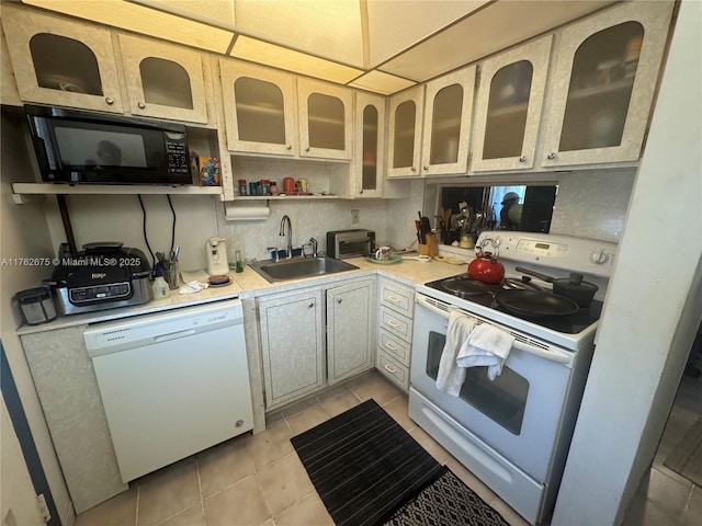 kitchen featuring white appliances, open shelves, light tile patterned flooring, a sink, and light countertops