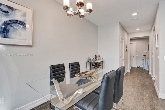 dining area featuring recessed lighting, baseboards, a notable chandelier, and wood finished floors