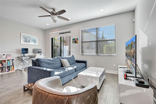 living room featuring a ceiling fan, recessed lighting, wood finished floors, and baseboards