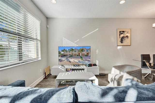 living area featuring wood finished floors, recessed lighting, and baseboards