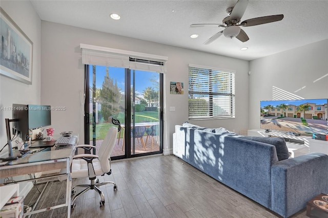 office featuring a ceiling fan, recessed lighting, wood finished floors, and a textured ceiling