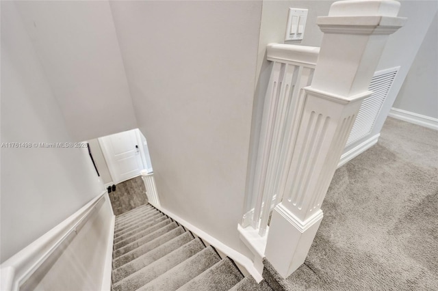 stairway featuring carpet and baseboards