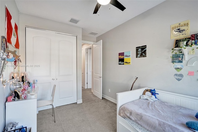 bedroom with ceiling fan, visible vents, a closet, and light carpet