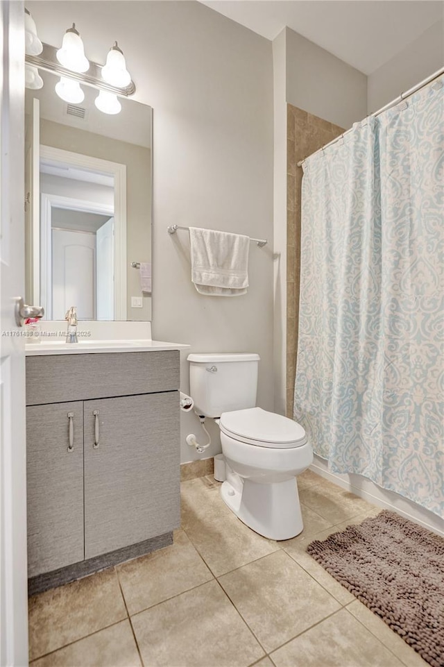 full bathroom featuring visible vents, toilet, a shower with shower curtain, tile patterned floors, and vanity