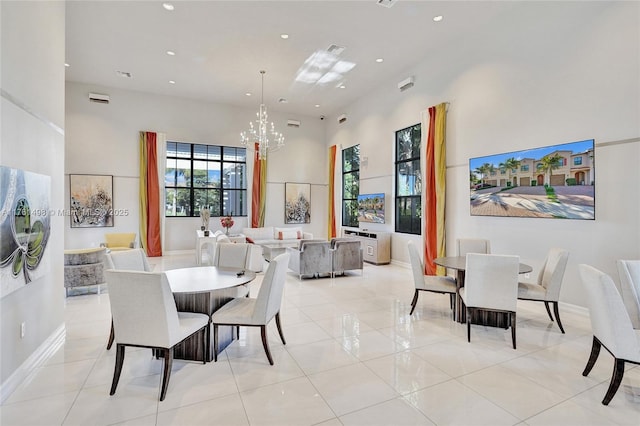 dining area featuring light tile patterned flooring, recessed lighting, an inviting chandelier, and a towering ceiling