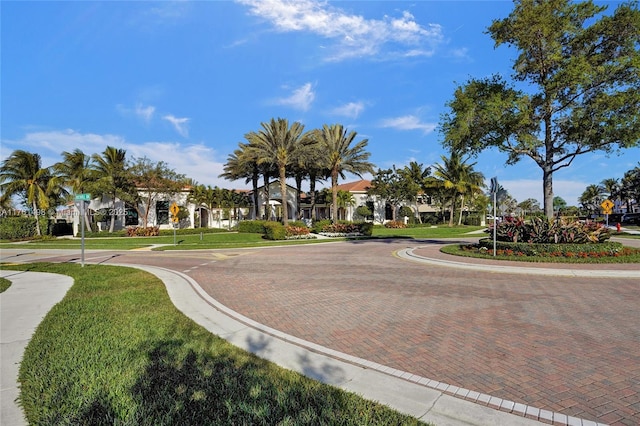 view of road with curbs, traffic signs, and sidewalks