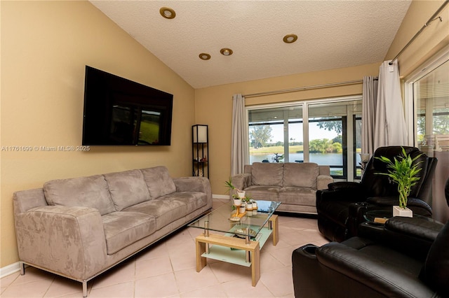 living room featuring light tile patterned floors, baseboards, a textured ceiling, and vaulted ceiling