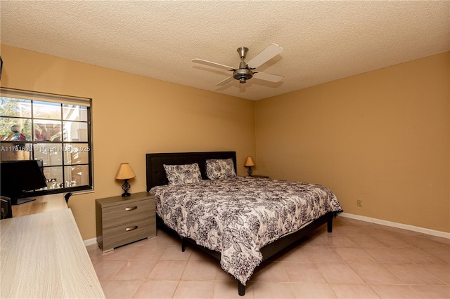 bedroom featuring light tile patterned floors, baseboards, a textured ceiling, and ceiling fan