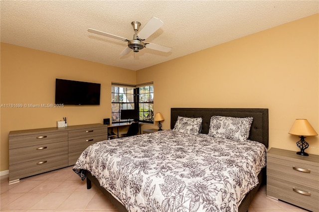 bedroom with light tile patterned floors, a textured ceiling, and a ceiling fan