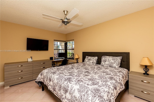bedroom featuring light tile patterned floors, a textured ceiling, and ceiling fan