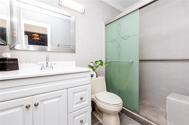 bathroom with a shower stall, tile walls, crown molding, toilet, and vanity