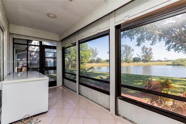 unfurnished sunroom with a water view