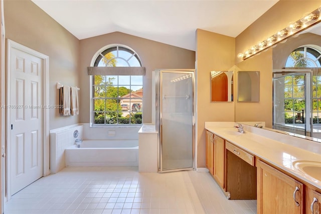 full bathroom with tile patterned floors, a garden tub, a shower stall, double vanity, and lofted ceiling