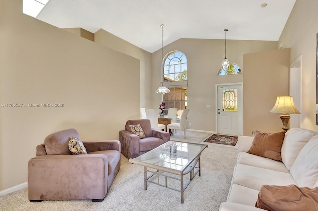 living area featuring high vaulted ceiling, carpet, and baseboards