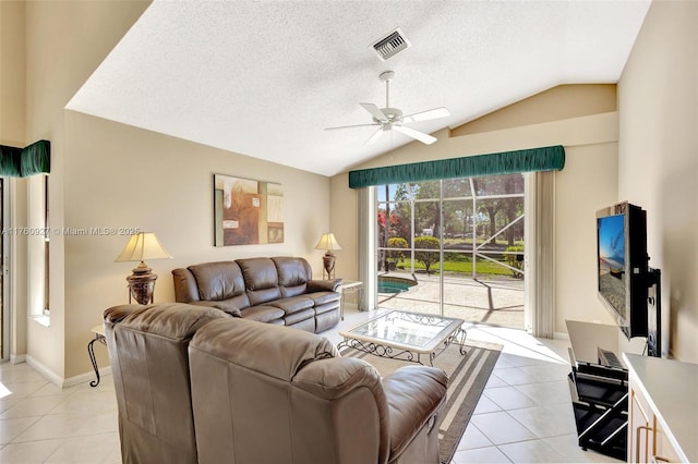 living room featuring visible vents, lofted ceiling, light tile patterned flooring, ceiling fan, and a textured ceiling