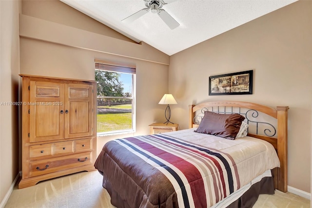 bedroom with baseboards, light colored carpet, lofted ceiling, a textured ceiling, and a ceiling fan