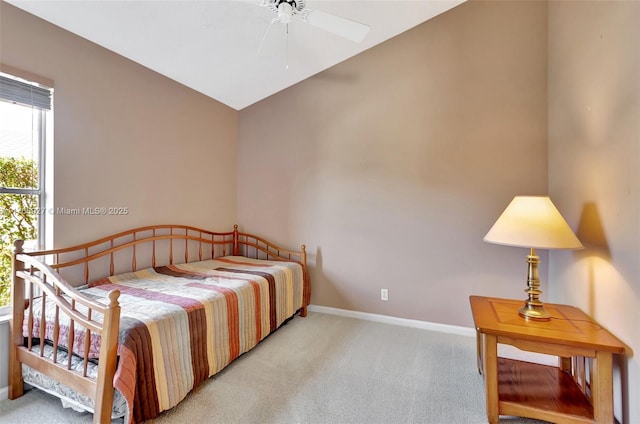 carpeted bedroom featuring baseboards and vaulted ceiling