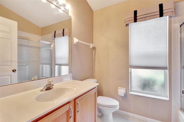 bathroom featuring baseboards, toilet, vaulted ceiling, a shower with shower door, and vanity