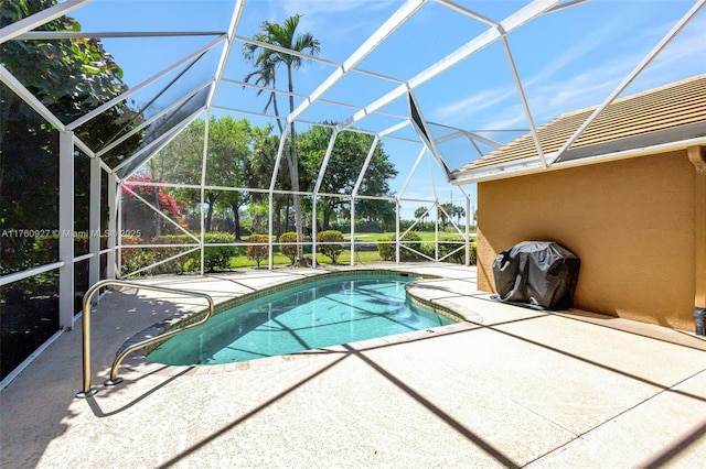 pool with glass enclosure and a patio