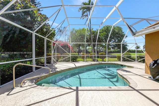 outdoor pool featuring glass enclosure and a patio