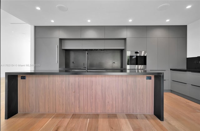 kitchen featuring dark countertops, gray cabinetry, and modern cabinets