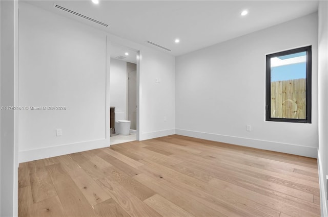 empty room with recessed lighting, visible vents, baseboards, and light wood finished floors