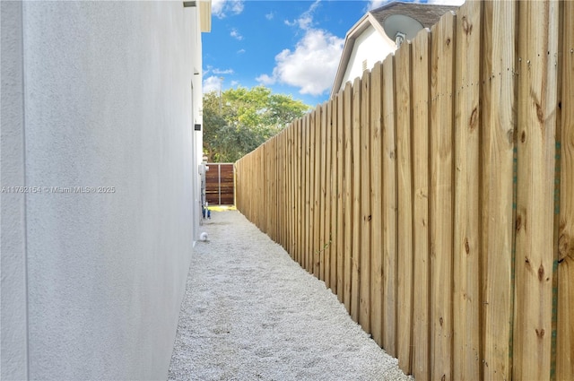 view of home's exterior with stucco siding and fence