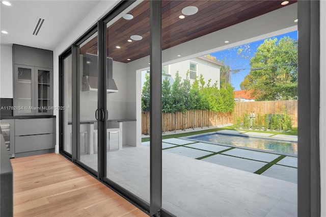 doorway to outside with recessed lighting, visible vents, and light wood-style flooring