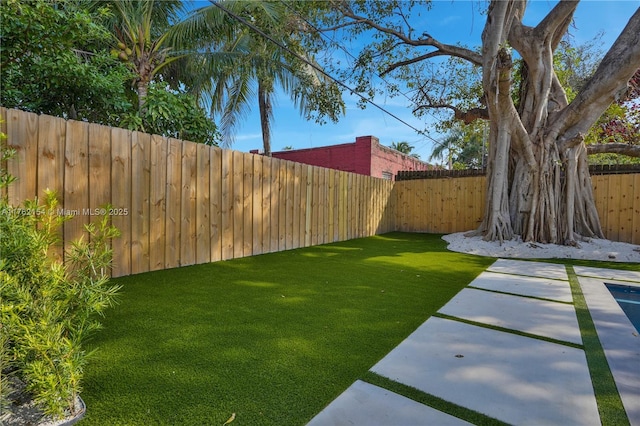 view of yard with a fenced backyard