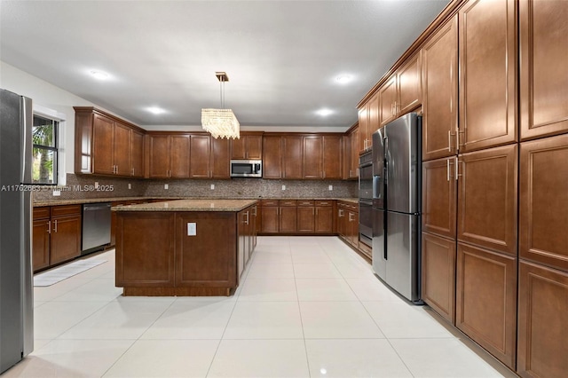 kitchen with stone countertops, decorative light fixtures, a kitchen island, backsplash, and stainless steel appliances