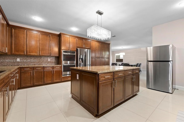 kitchen featuring light tile patterned floors, stone counters, stainless steel appliances, decorative backsplash, and a center island