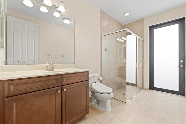 full bathroom featuring toilet, a stall shower, vanity, and tile patterned flooring