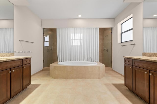 full bath with a wealth of natural light, a shower stall, and vanity