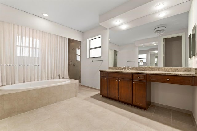 bathroom with a bath, a stall shower, vanity, and a wealth of natural light