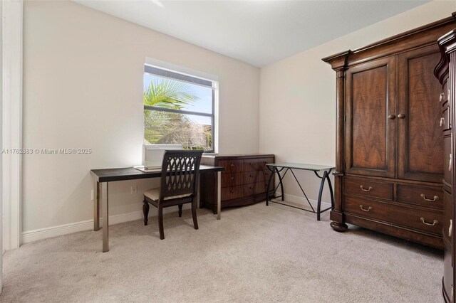 office space with baseboards and light colored carpet